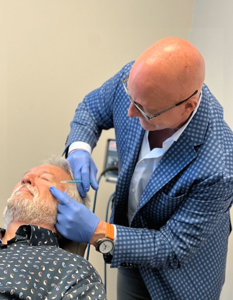 Dr. Brenton Koch performing a BOTOX treatment on a patient