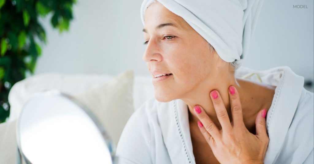 Woman (model) examining her face before a laser treatment